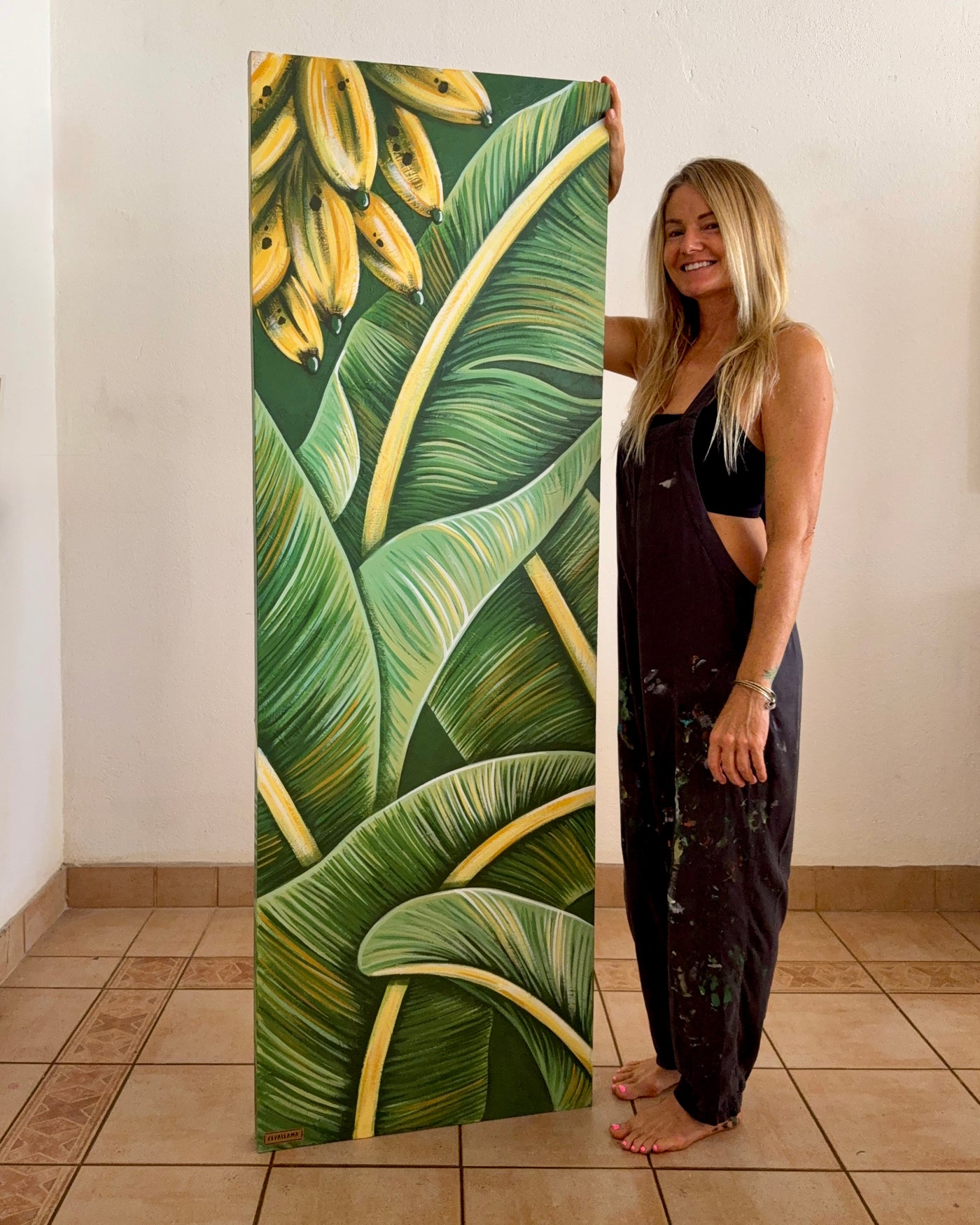 artist Pepa Ivanoff (pepallama) with an original banana leaf painting in her Costa Rica studio