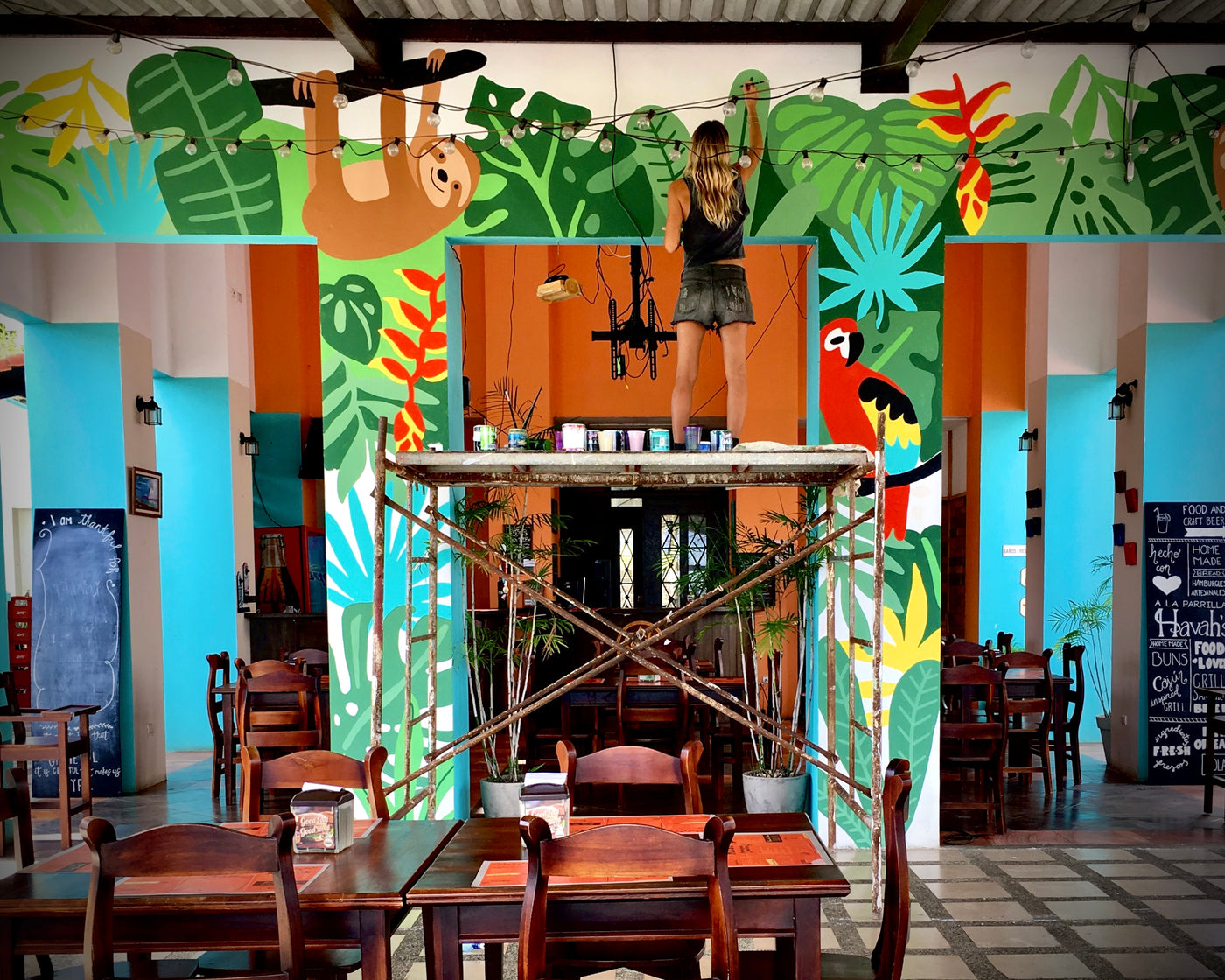 pepallama on location painting tropical jungle mural in Costa Rica 
