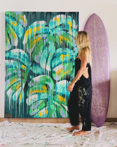 artist and surfer pepallama in her home studio in Costa Rica painting original tropical artwork on canvas